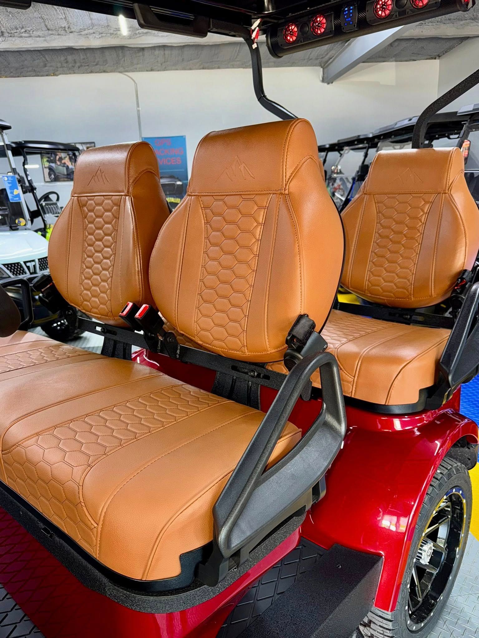 Brown leather golf cart seats in a red cart.