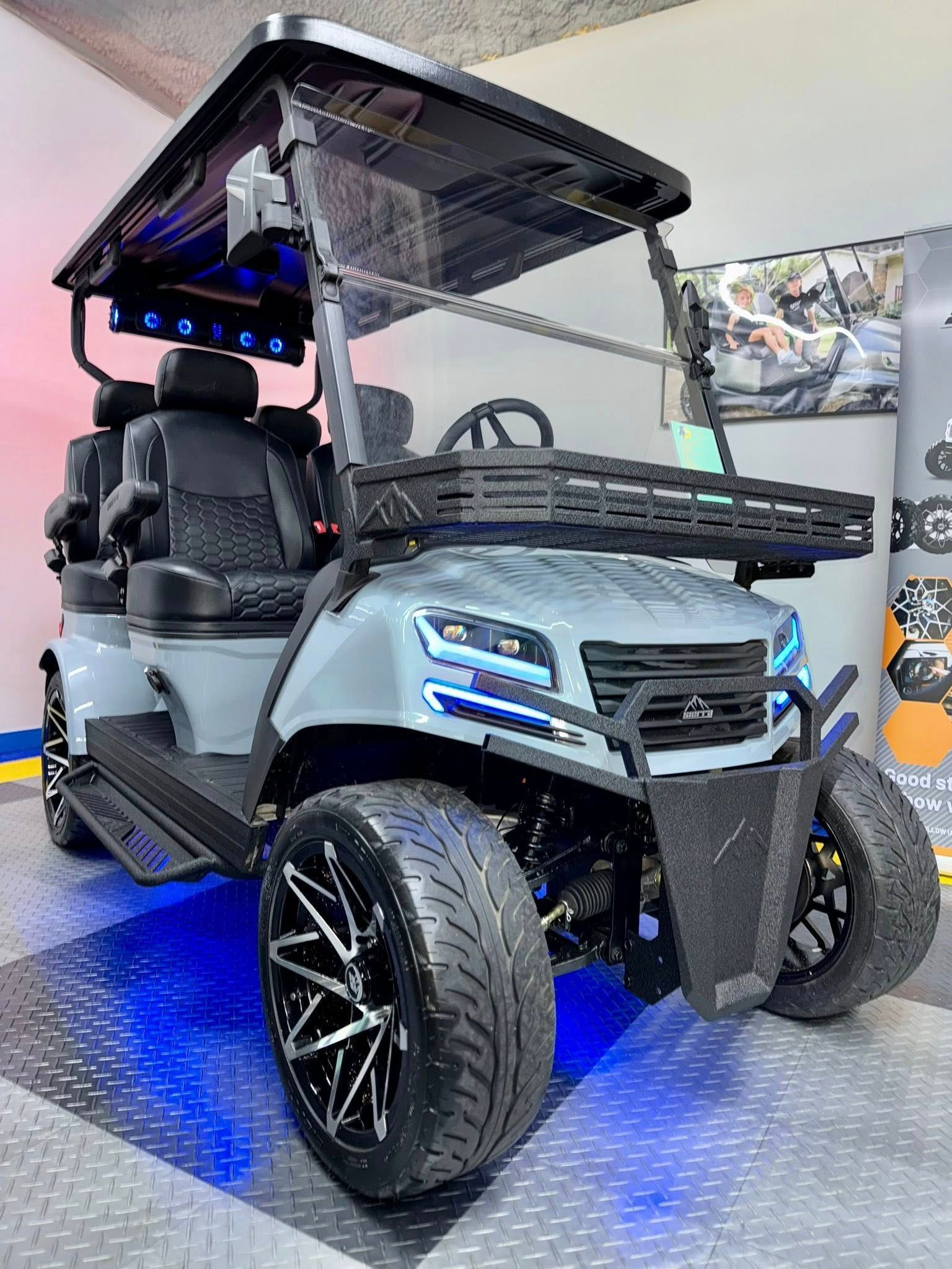 Gray custom golf cart with black and silver accents, off-road tires, and LED lighting.