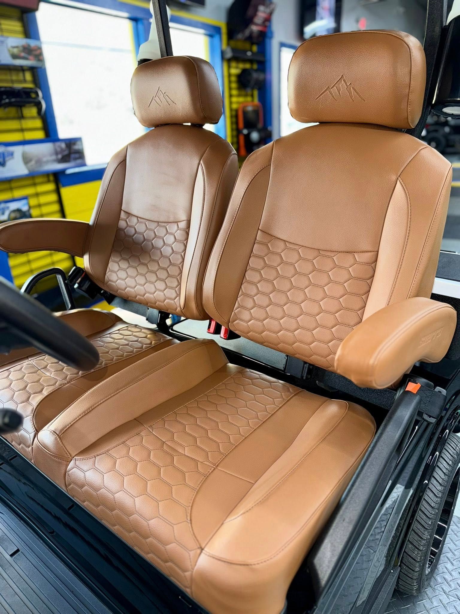 Tan golf cart seats with a quilted pattern.