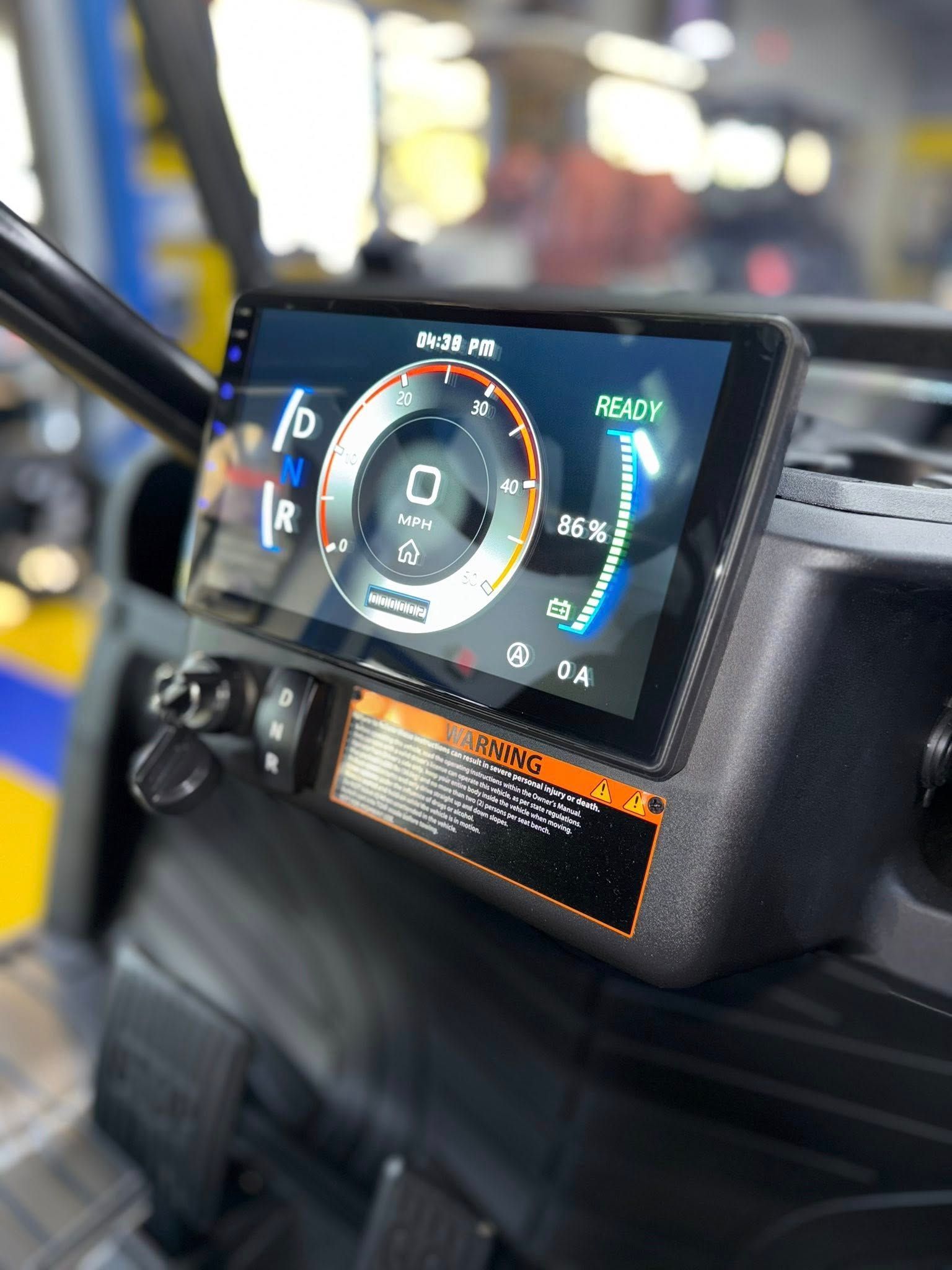 Dashboard display in a vehicle showing speed, gear, and other information.