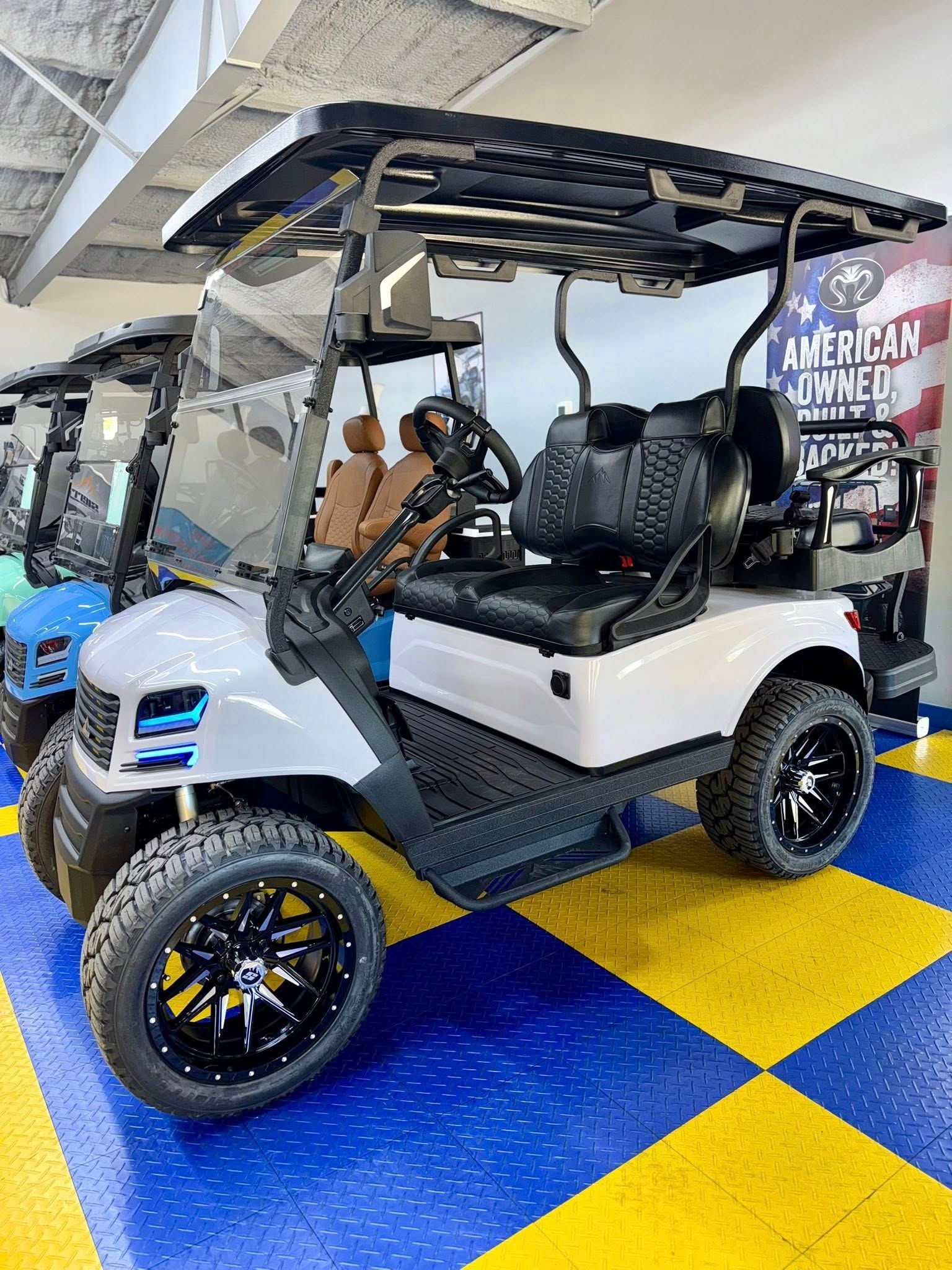 White golf cart with black accents, black wheels, and a patterned roof.