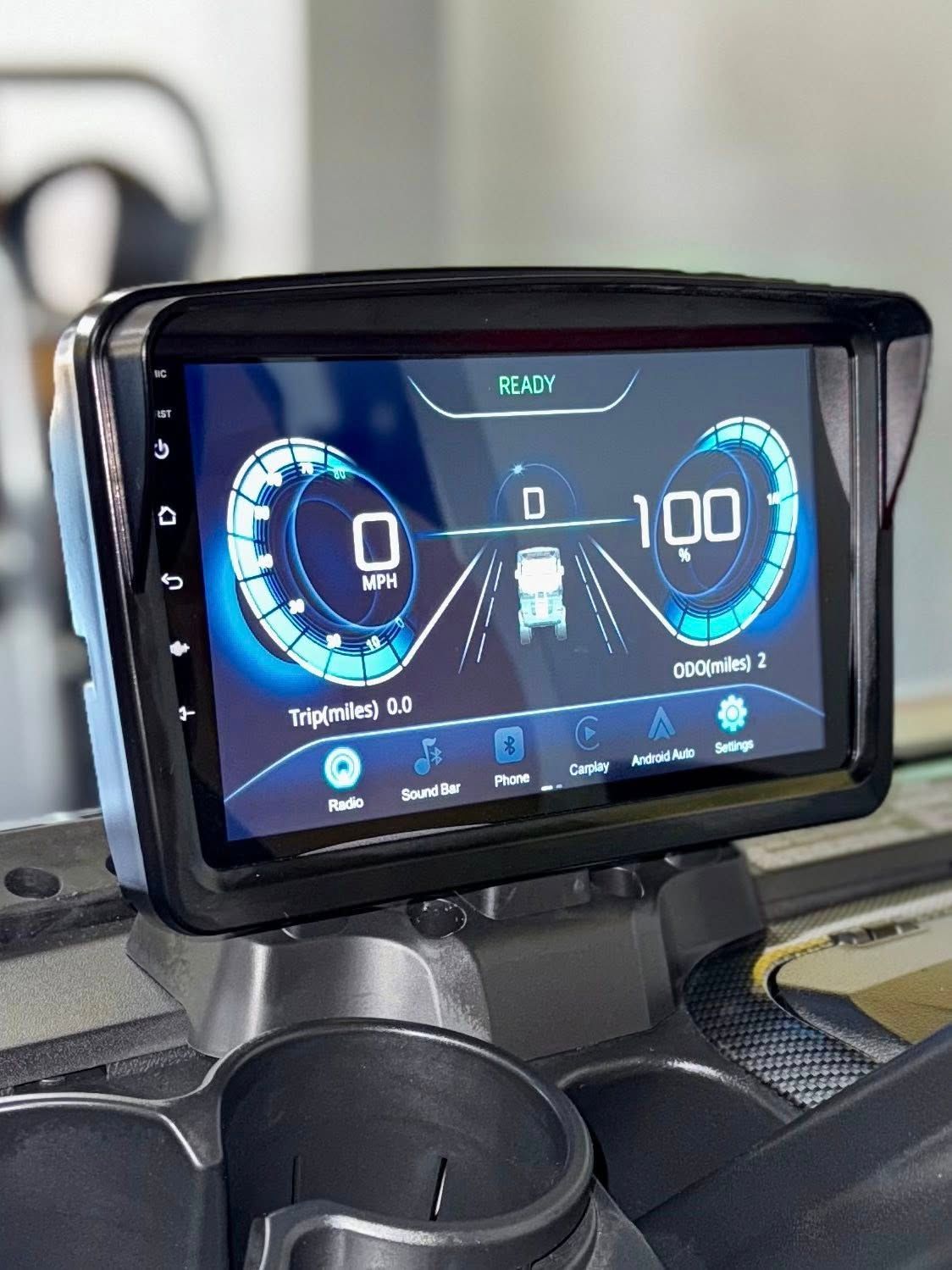 Digital car dashboard displaying speedometer, lane indicators, and vehicle information. The screen is mounted in a vehicle's console.