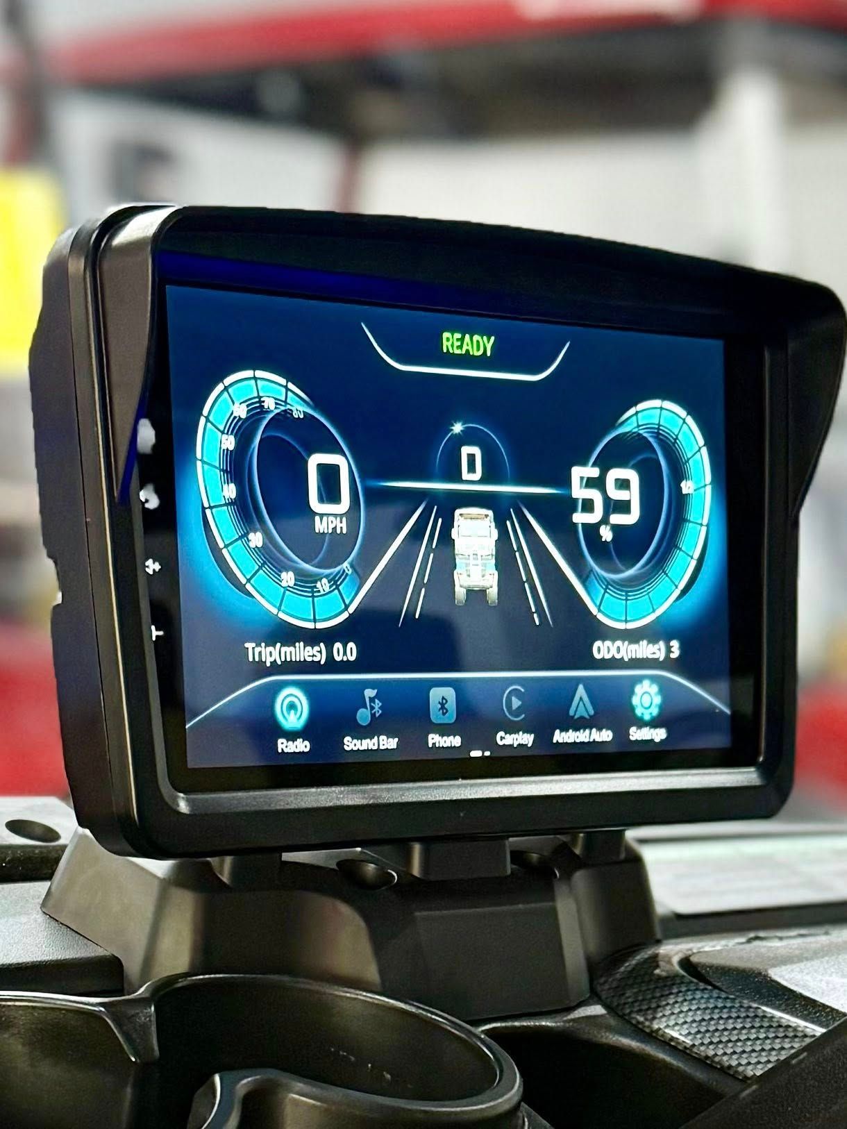 Digital dashboard displaying vehicle speed, trip data, and other information. It shows a truck driving on a road.