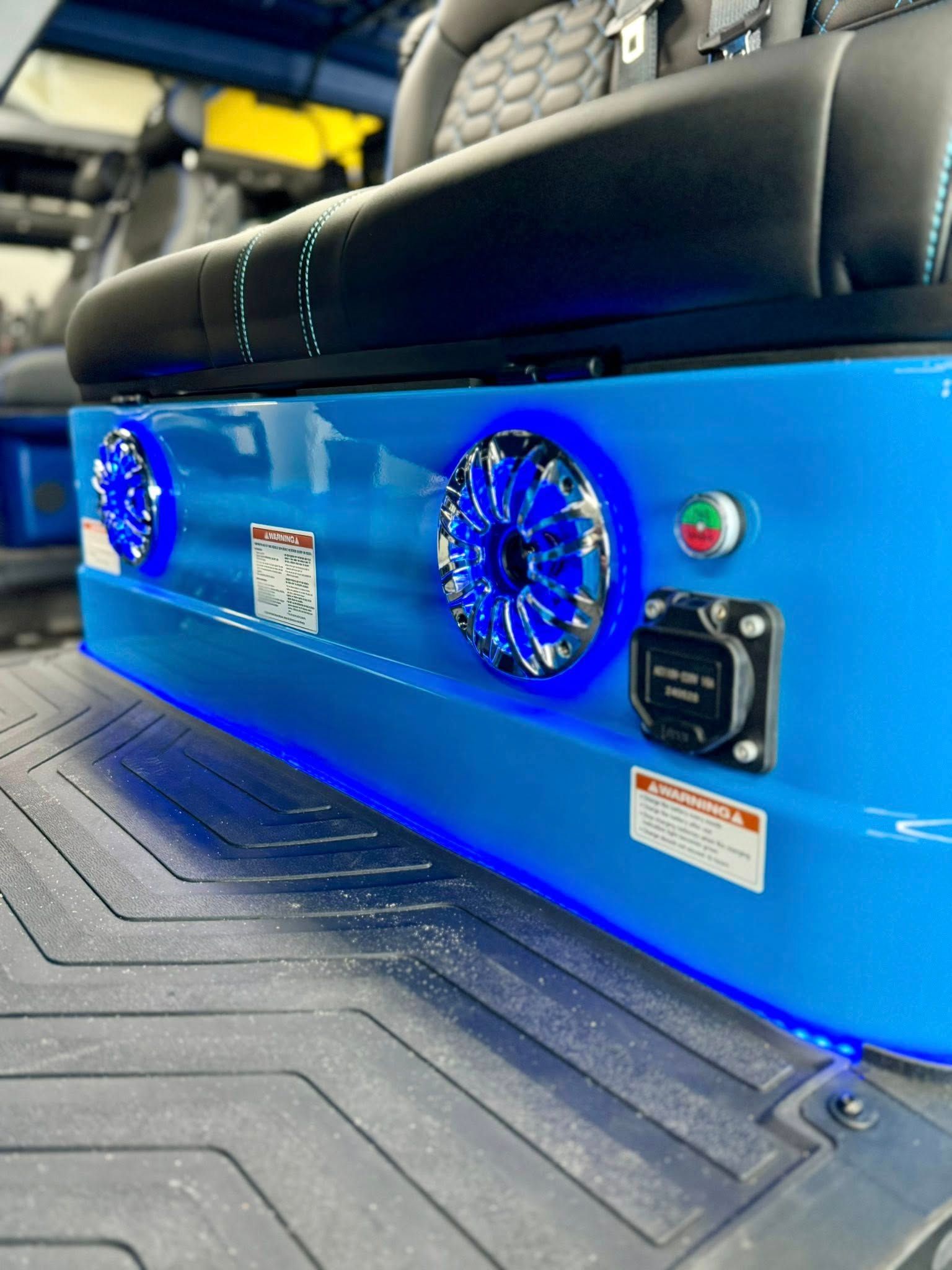 Blue custom car audio system with speakers and LED lights.
