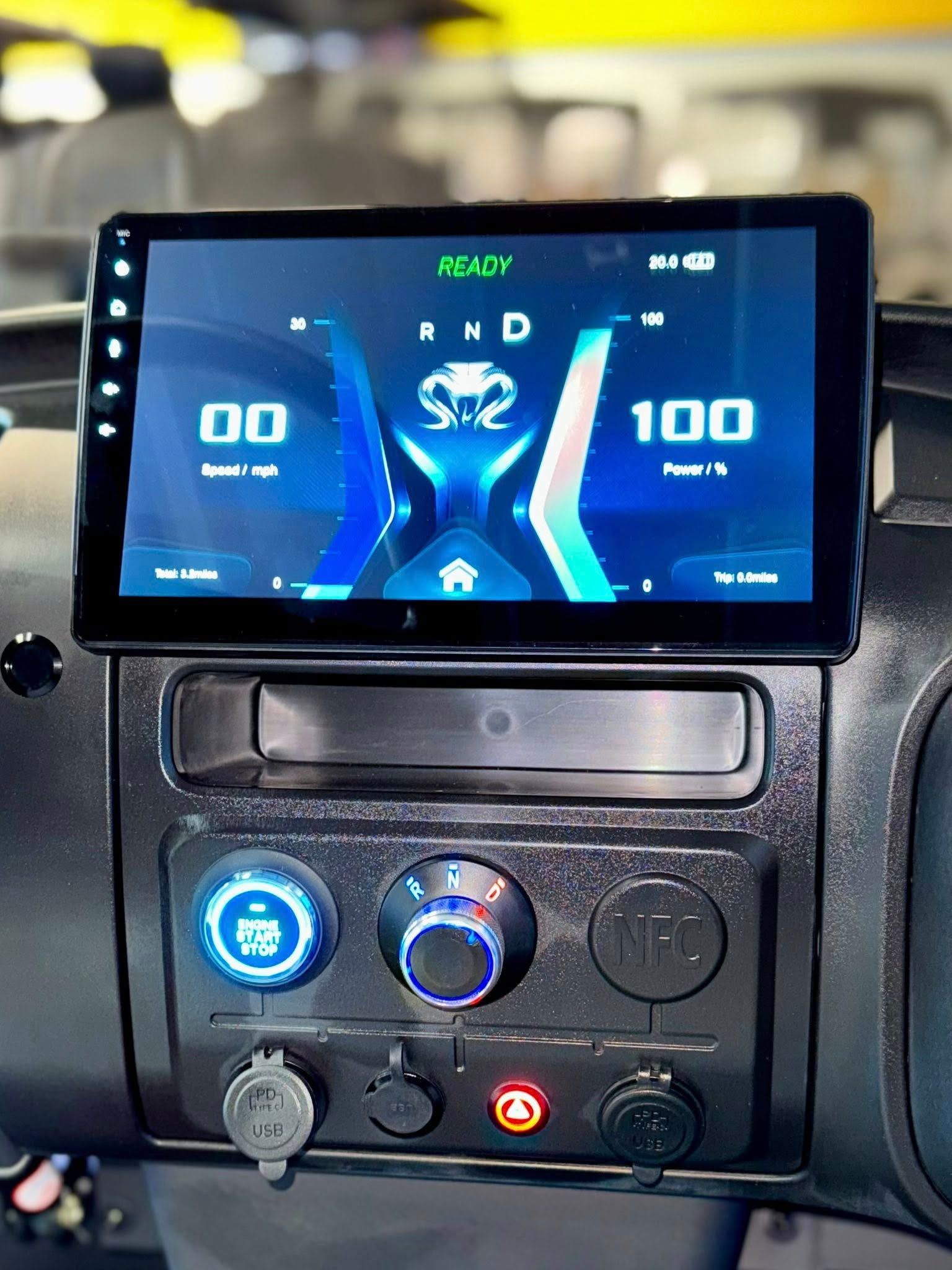 Dashboard with a large touchscreen display showing vehicle information, with blue lighting accents.