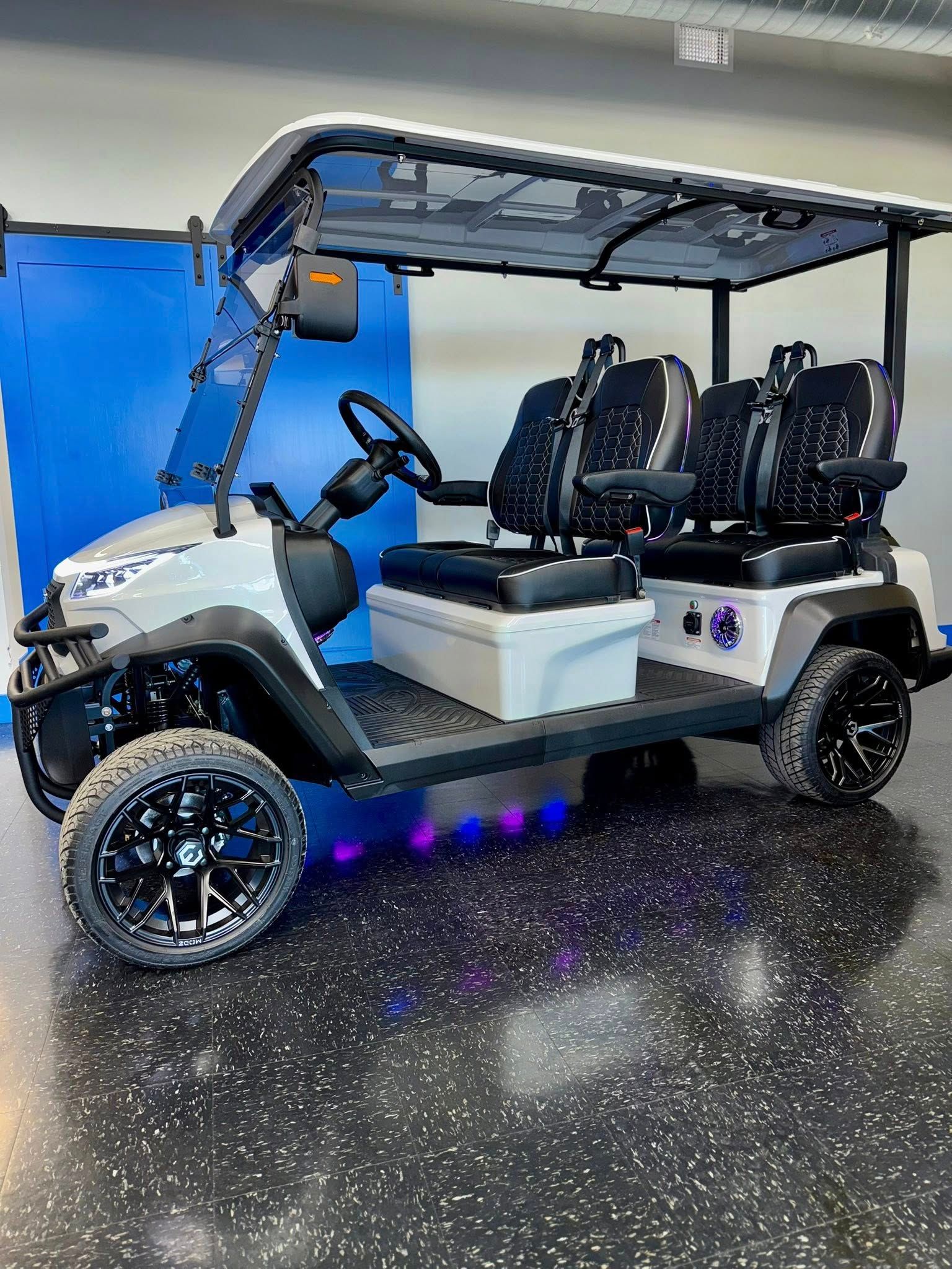 Gray golf cart with black seats, wheels, and under-glow lights.