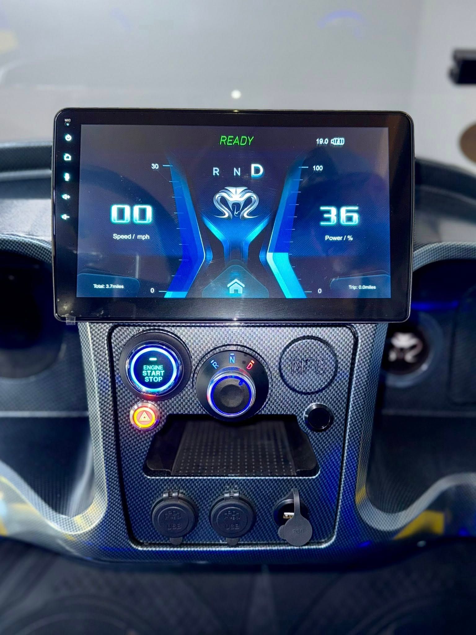Dashboard with digital display showing speedometer and other vehicle information. Carbon fiber trim.
