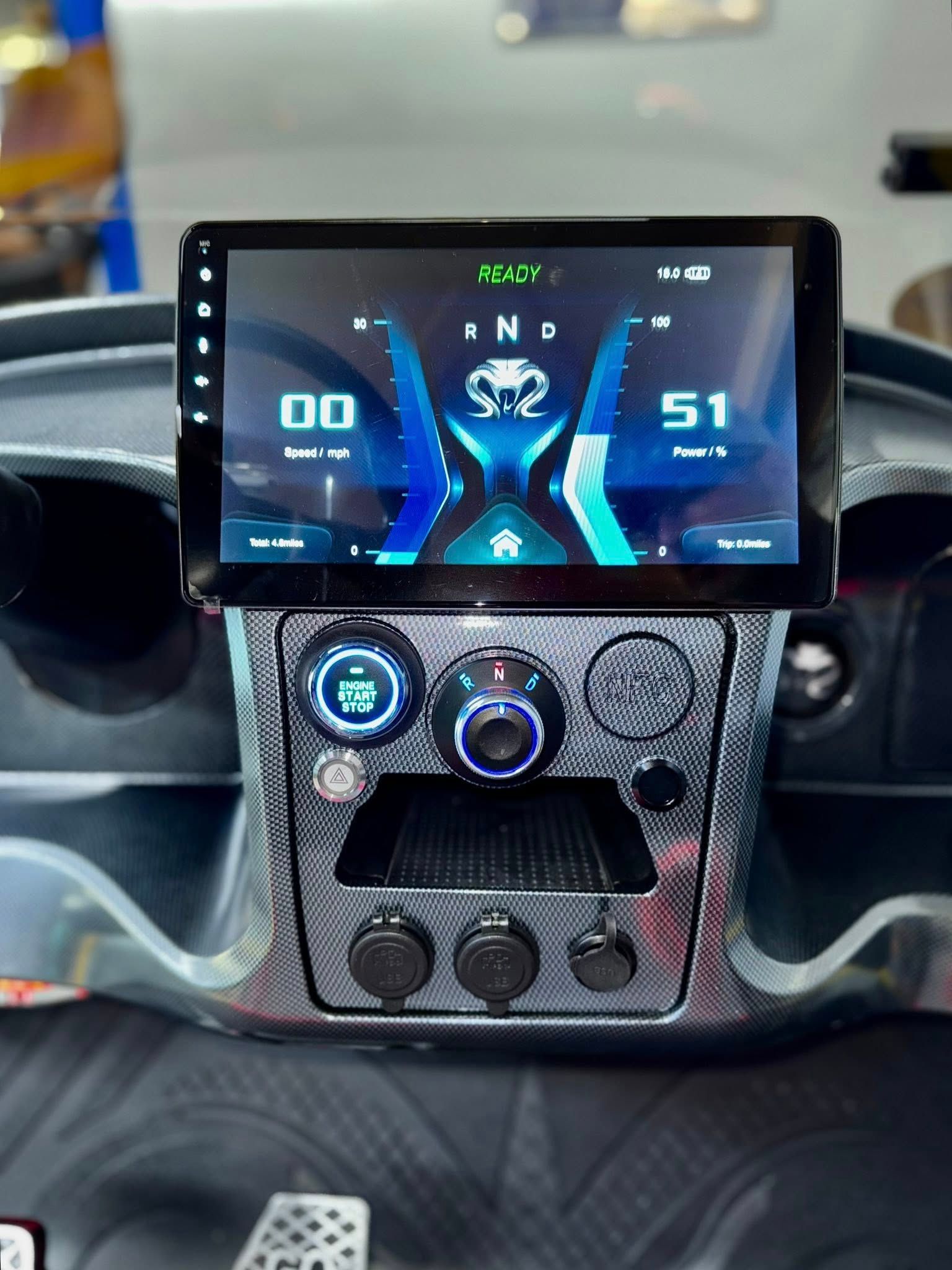 Dashboard with digital display showing vehicle information, black and blue design.