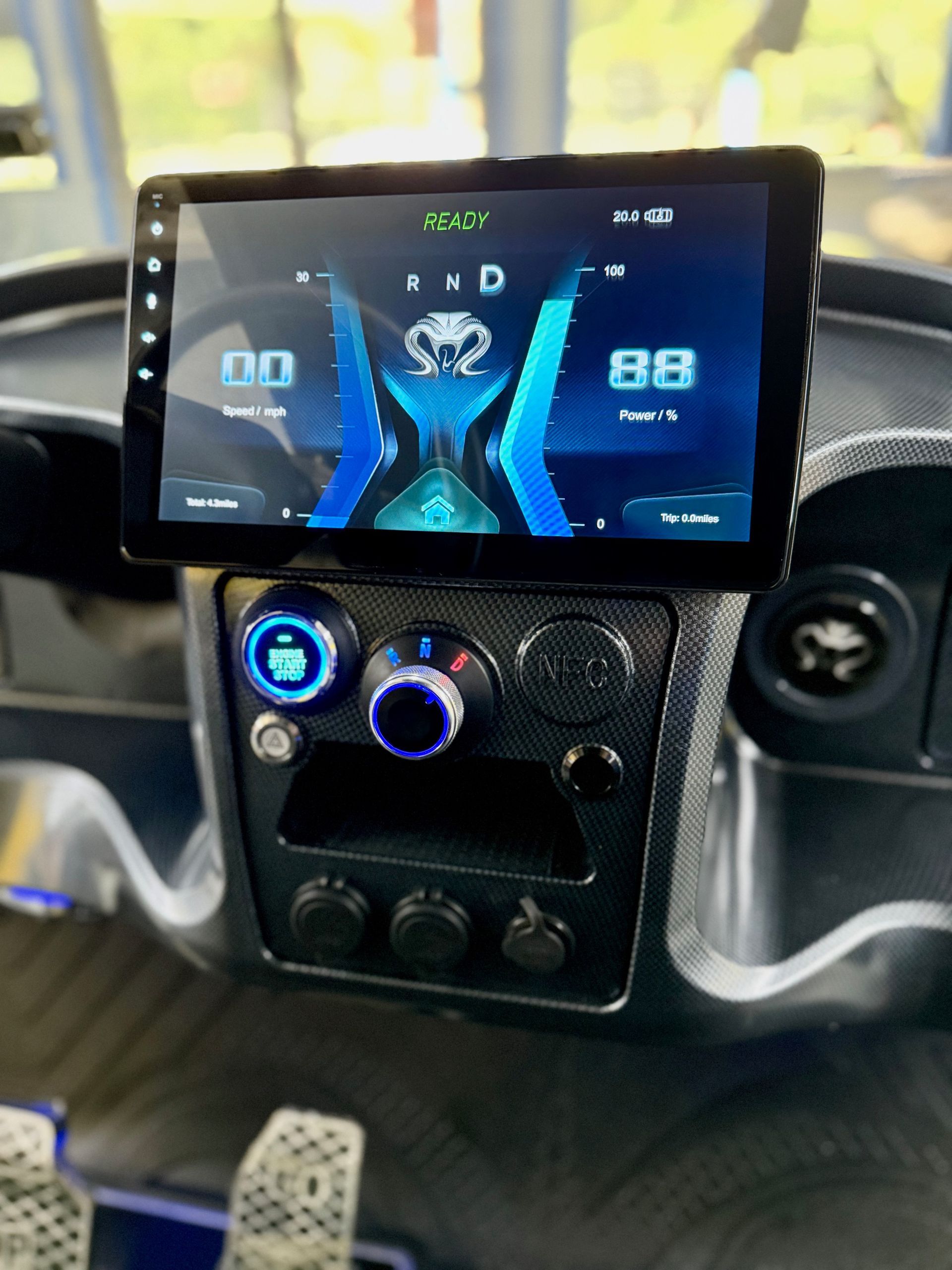 Dashboard of a vehicle with a digital display showing speed.