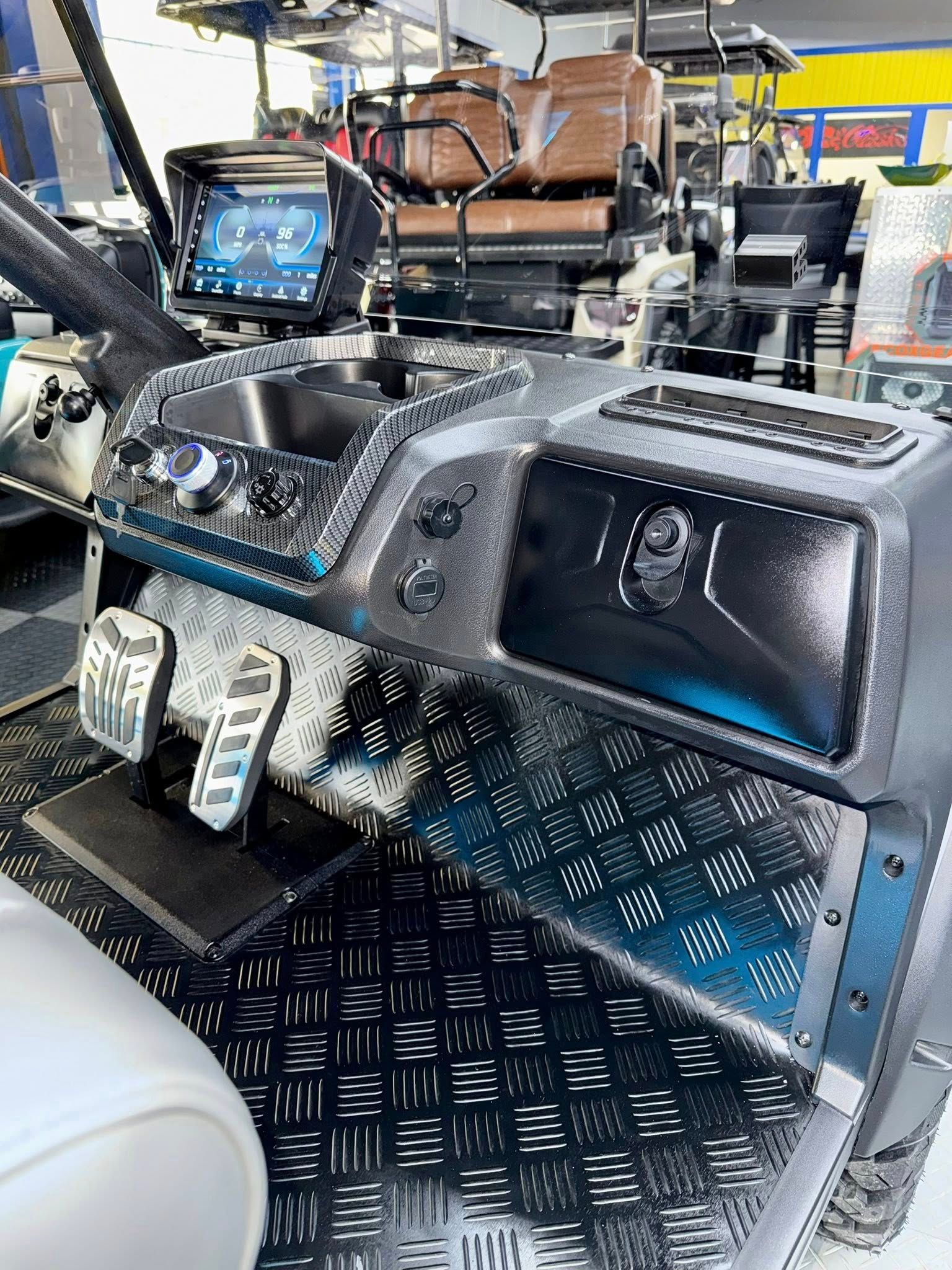 Custom golf cart interior with chrome, blue accents, and a large touchscreen display.