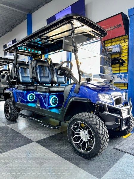 A blue golf cart is parked in a store.