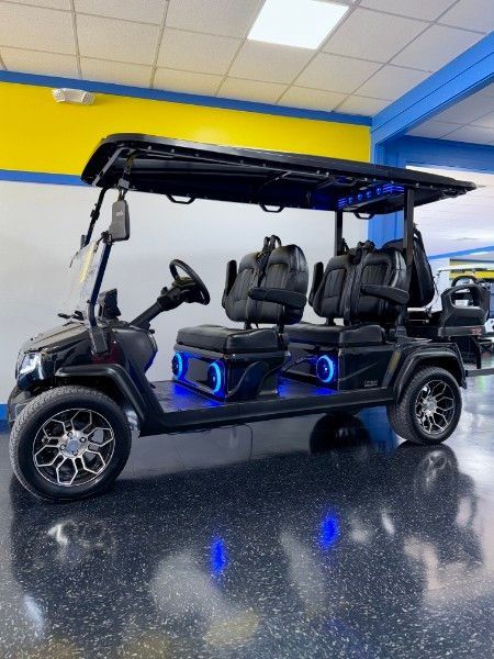 A black golf cart is parked in a showroom
