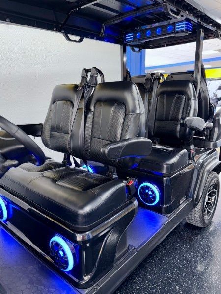 The inside of a golf cart with blue lights on it.