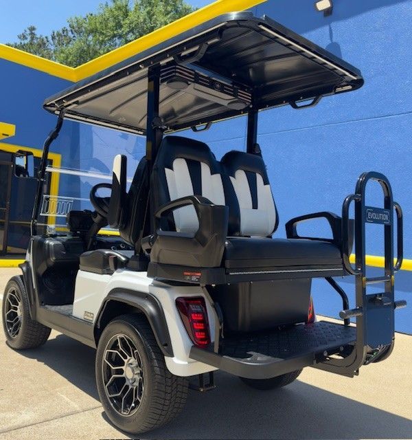 A golf cart is parked in front of a blue building