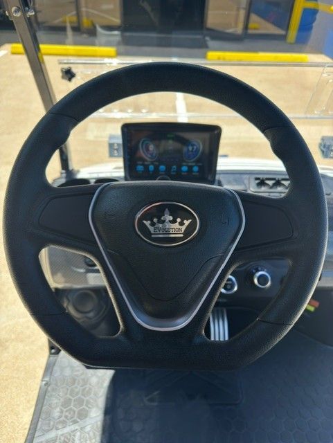 A golf cart steering wheel with a crown on it