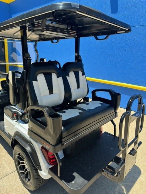 A golf cart is parked in front of a blue wall