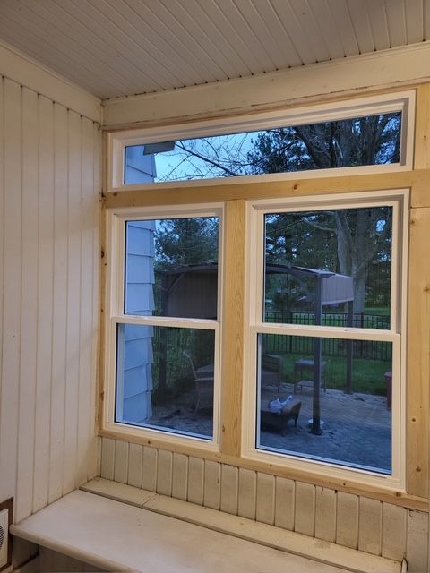 A window in a room with a bench in front of it