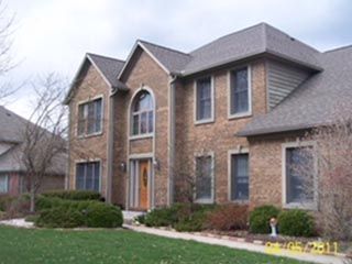 A large brick house with a gray roof