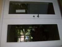 A close up of a window with a reflection of a building in it.