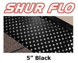 A black rug with white polka dots on it is sitting on top of a roof.