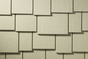 A close up of a white shingle siding on a house.