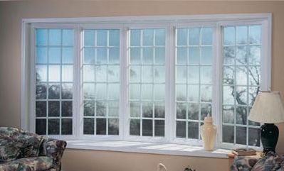 A living room with a large window and a couch.