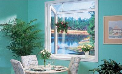 A dining room with a table and chairs and a window with a view of a lake.