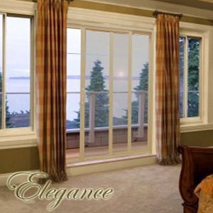 A bedroom with sliding glass doors and the word elegance on the bottom