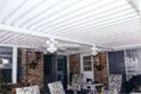 A patio with a white awning and a ceiling fan.