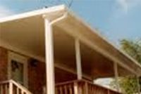 A house with a porch and a white gutter.
