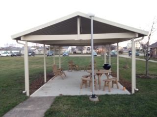 A gazebo with a table and chairs underneath it