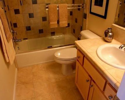 A bathroom with a toilet , sink and bathtub