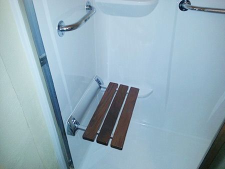 A shower with a wooden bench in it