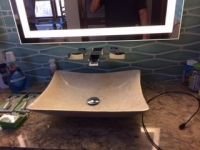 A bathroom sink with a mirror above it.