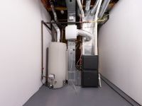 A basement with a water heater and a furnace.