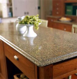 A counter top with a vase of grapes on it