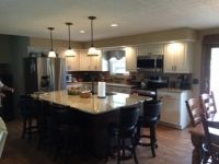 A kitchen with a large island in the middle of the room.