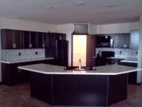 There is a large island in the middle of the kitchen.