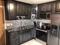 A kitchen with stainless steel appliances and granite counter tops.