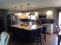 There is a large island in the middle of the kitchen.