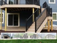 A blue house with a deck and stairs leading up to it.
