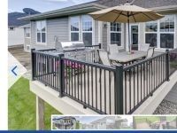 A deck with a table and chairs and an umbrella in front of a house.