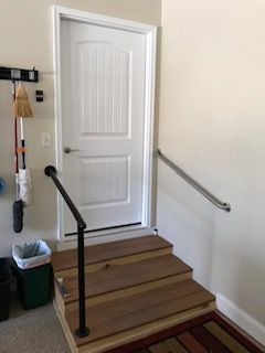 A door with stairs leading up to it and a railing.