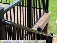 A deck with a black railing and stairs leading up to it.