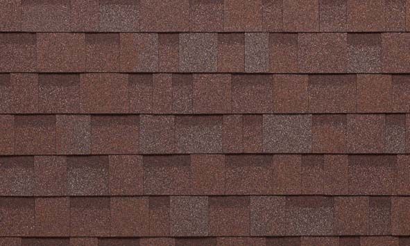 A close up of a row of brown shingles on a roof.