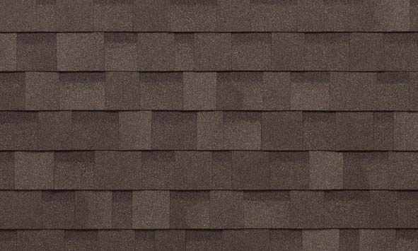 A close up of a row of brown shingles on a roof.