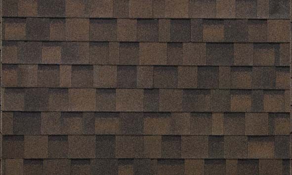 A close up of a roof with brown shingles