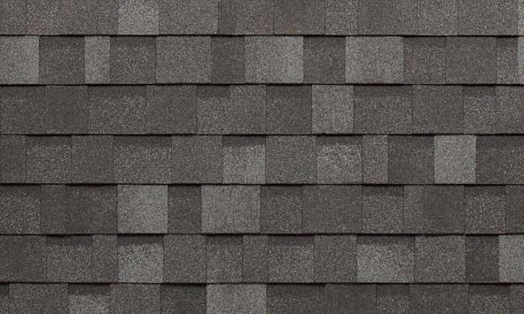A close up of a row of gray shingles on a roof.