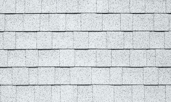 A close up of a row of white tiles on a wall.