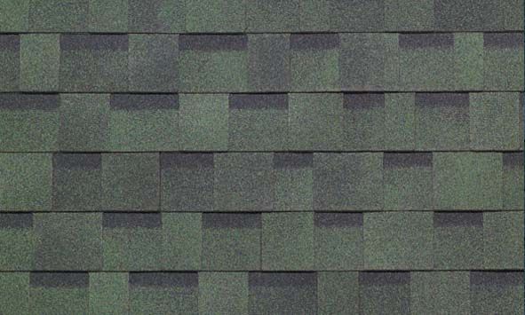 A close up of a roof with green and black shingles.